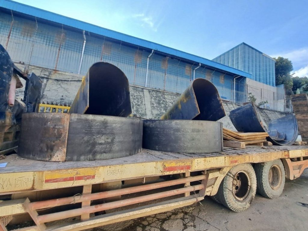 Bending and rolling steel plates for Kort nozzle fabrication on a tugboat at Batam workshop
