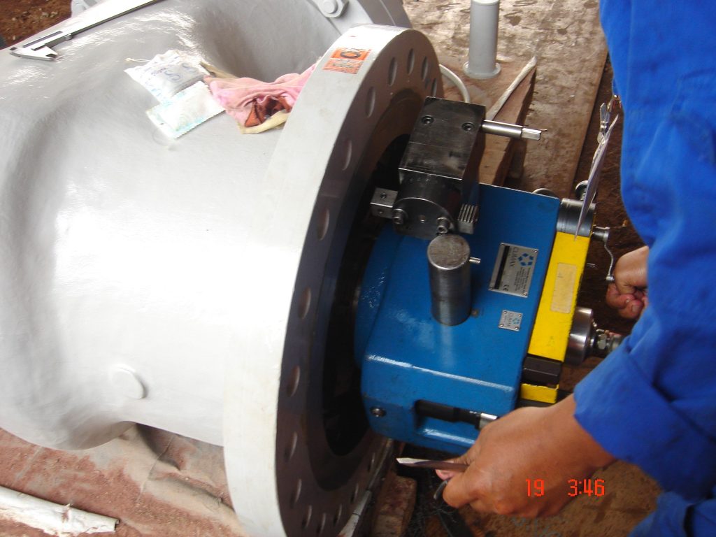 Flange facing process using portable machine on site